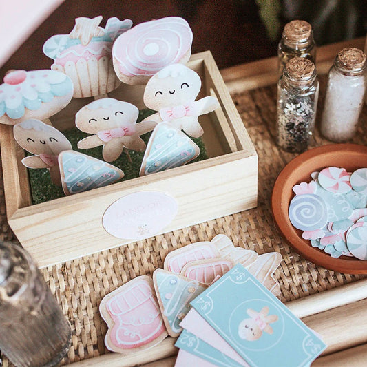 Printable Nutcracker themed dramatic play set with various colorful cards and cutouts displayed in a wooden box.