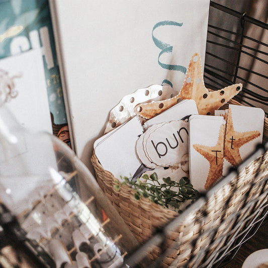 A basket containing educational materials related to oceanography, including printouts and a toy squid.